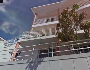 a building with a balcony with a tree on it at Madeira Studio Salvador Rental in Funchal