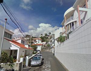 a street with cars parked on the side of a building at Madeira Studio Salvador Rental in Funchal