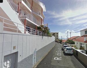 a car parked in a parking lot next to a building at Madeira Studio Salvador Rental in Funchal
