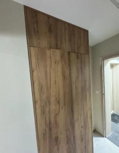 a wooden door in the corner of a room at Apartament pod Krasnalem in Wrocław