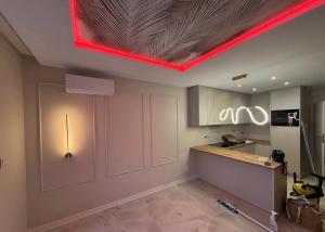 a kitchen with a red light on the ceiling at Apartament pod Krasnalem in Wrocław +8 photos