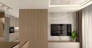 a living room with a television on a wall at Apartament pod Krasnalem in Wrocław