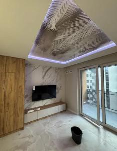 a living room with a flat screen tv on a ceiling at Apartament pod Krasnalem in Wrocław