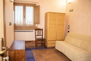 a living room with a couch and a chair at Agriturismo Paradiso di Barchi in Lido Di Fondi