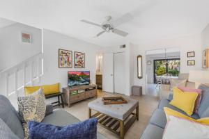 a living room filled with furniture and a ceiling fan at San Marco Villas S-7 in Marco Island