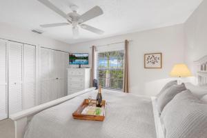 a bedroom with a bed and a ceiling fan at San Marco Villas S-7 in Marco Island +44 photos