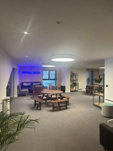 a living room with a table and a couch and chairs at Apex2100 International Ski Academy Tignes in Tignes