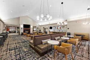 a lobby with couches and tables and a bar at Homewood Suites Lancaster in Lancaster