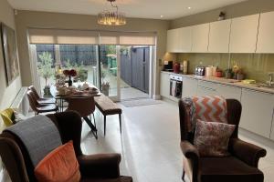 a kitchen with a table and chairs and a dining room at 4 Bed House Sleeps 7 - Parking Garden Wifi in Killarney