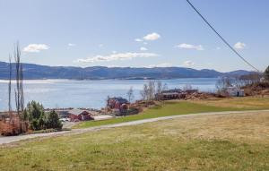 a view of a large body of water with mountains at 2 Bedroom Stunning Home In Bjugn in Moen +13 photos