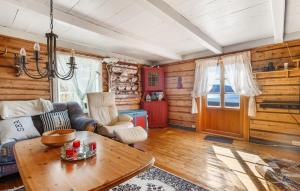a living room with a couch and a table at 2 Bedroom Stunning Home In Bjugn in Moen