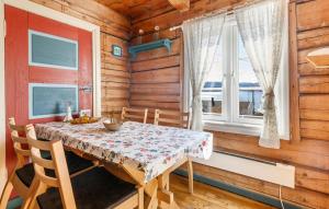 a dining room with a table and chairs and a window at 2 Bedroom Stunning Home In Bjugn in Moen