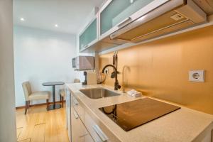 a kitchen with a sink and a counter top at Apartment T1 - Porto in Porto