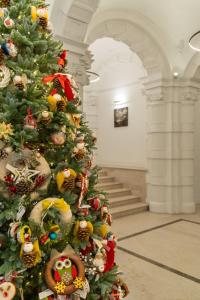 a christmas tree with ornaments on it in a building at Hilton Garden Inn Bucharest Old Town in Bucharest