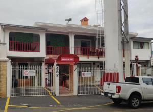 a white truck parked in front of a building at Aparthotel Maison Suisse in Asuncion
