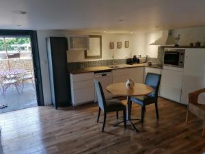 a kitchen with a table and two chairs and a table at La Corentine in Bandol