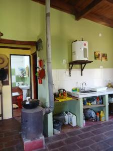 a kitchen with a stove in the middle of a room at Cabaña Catelmo in Colalao del Valle