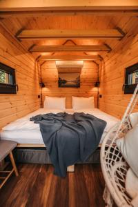 a bedroom with a bed in a log cabin at Berg & Natur - Cozy house in Altenmarkt im Pongau