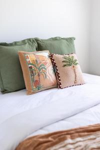 a pile of pillows sitting on top of a bed at Oceans 21 Caves Beach in Caves Beach