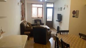 a living room with a couch and chairs and a table at family house in Aghk'ilisa +1 photo