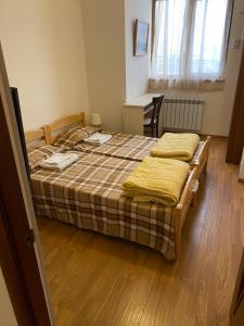 a bedroom with two beds and a wooden floor at family house in Aghk'ilisa
