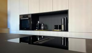 a kitchen with a counter with a microwave and a stove at Haus Filomena Oetz in Oetz +39 photos