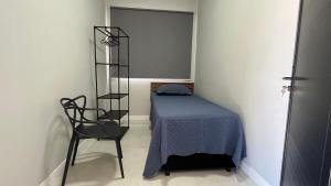 En eller flere senge i et værelse på Casa Vila Muriqui