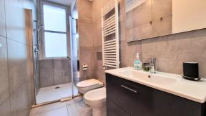 a bathroom with a sink and a toilet and a shower at Campo Marzio 6 in Trieste