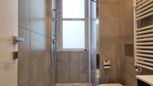 a bathroom with a shower with a window at Campo Marzio 6 in Trieste