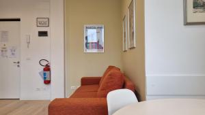 a living room with a orange couch in a room at Campo Marzio 6 in Trieste +14 photos
