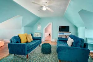 a living room with two blue chairs and a ceiling at Capitol-Side • Downtown • Attic Harry-Potter Door in Cheyenne