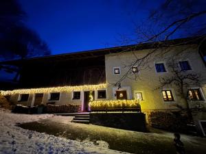 a house with christmas lights on it at night at Unterhecherhof in Bannberg
