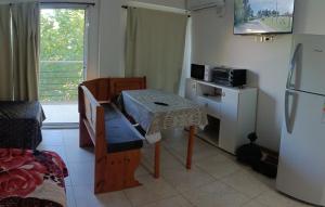 a small kitchen with a table and a refrigerator at Apartamento Monte Grande Centro in Monte Grande