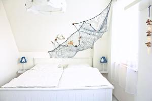 a bedroom with a bed with a net on the wall at Seestern in Neuenkirchen auf Rugen