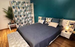 ein Schlafzimmer mit einem Bett und einer grünen Wand in der Unterkunft Chambre CLAIRIERE in Maizières-lès-Metz