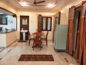 a kitchen and dining room with a table and a refrigerator at EnDai House - Kalyanpuri, Uppal in Hyderabad