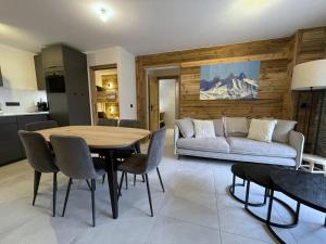 a living room with a table and a couch at Appartement Haut de Gamme neuf - 6 personnes - App 103 in Saint-Sorlin-dʼArves +16 photos