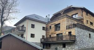 a building with balconies on the side of it at Appartement Haut de Gamme neuf - 6 personnes - App 103 in Saint-Sorlin-dʼArves