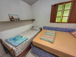 Giường trong phòng chung tại Chácara Esmeril