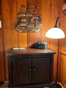 a black cabinet in a room with a lamp at Capitol-Side • Downtown • Basement Pirate Themed in Cheyenne +11 photos