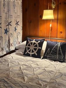 a bedroom with a bed with pillows with a wooden wall at Capitol-Side • Downtown • Basement Pirate Themed in Cheyenne