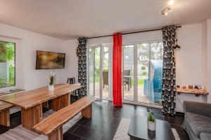 a living room with a table and a couch at Ferienhaus Kontraste 4m in Korswandt +8 photos