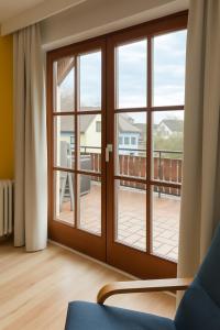 a room with a sliding glass door with a balcony at Fewo Mainau in Unteruhldingen