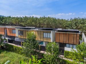 an image of an apartment building with trees in the background at 竹光别院 Bamboo Radiance Villa in Ban Thalat Choeng Thale