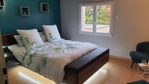 Voodi või voodid majutusasutuse Les Chambres des 4 Vents - Chambres doubles à l'étage toas