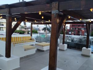 a pavilion with yellow and white benches on a roof at Hotel Playamar in Mazatlán