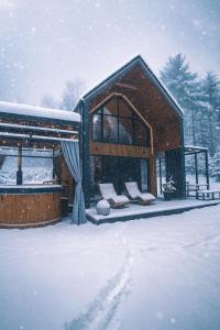 a log cabin in the snow with snowionage at Honey House Wierchy- prywatna strefa SPA in Jaszczurowa