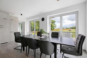 a kitchen and dining room with a table and chairs at Ferienhaus Ebbe in Schülp