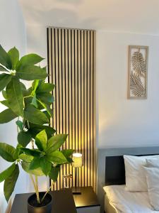 a bedroom with a plant on a table next to a bed at Guest House Rila in Govedartsi