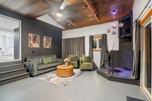 a living room with a couch and a table at Dual Home Retreat! Walk Between Both! Sleeps 28 in Newfield